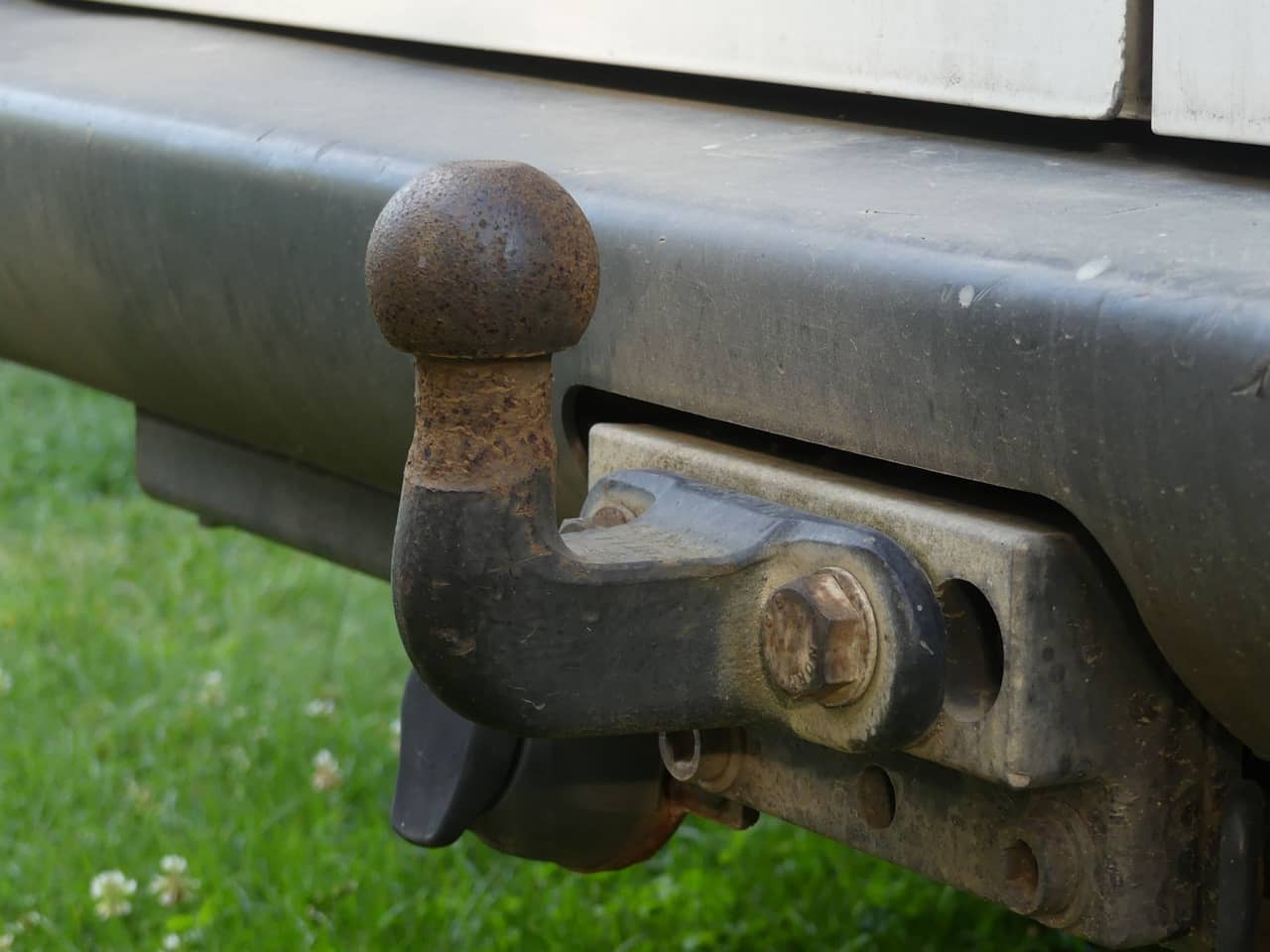 Close-up of a tow ball hitch on a vehicle's rear bumper