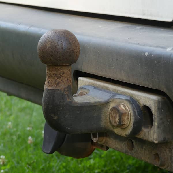 Close-up of a tow ball hitch on a vehicle's rear bumper